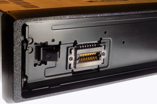 Alpine CD radio replacement bezel trim ring installed close-up on Alpine single-DIN radio face
