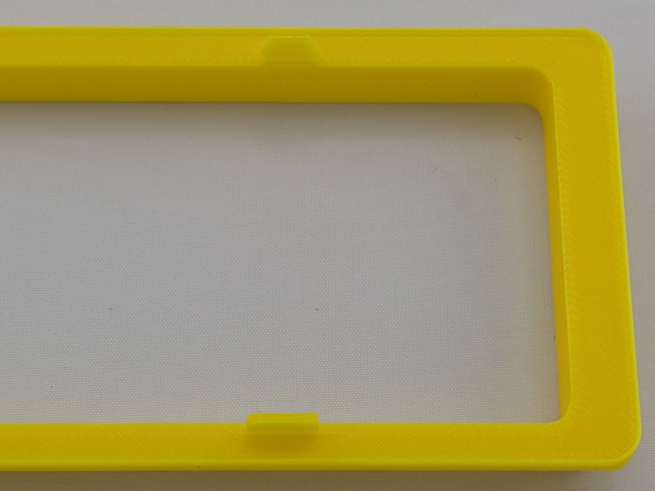 Yellow Alpine CD radio replacement bezel trim ring clip detail