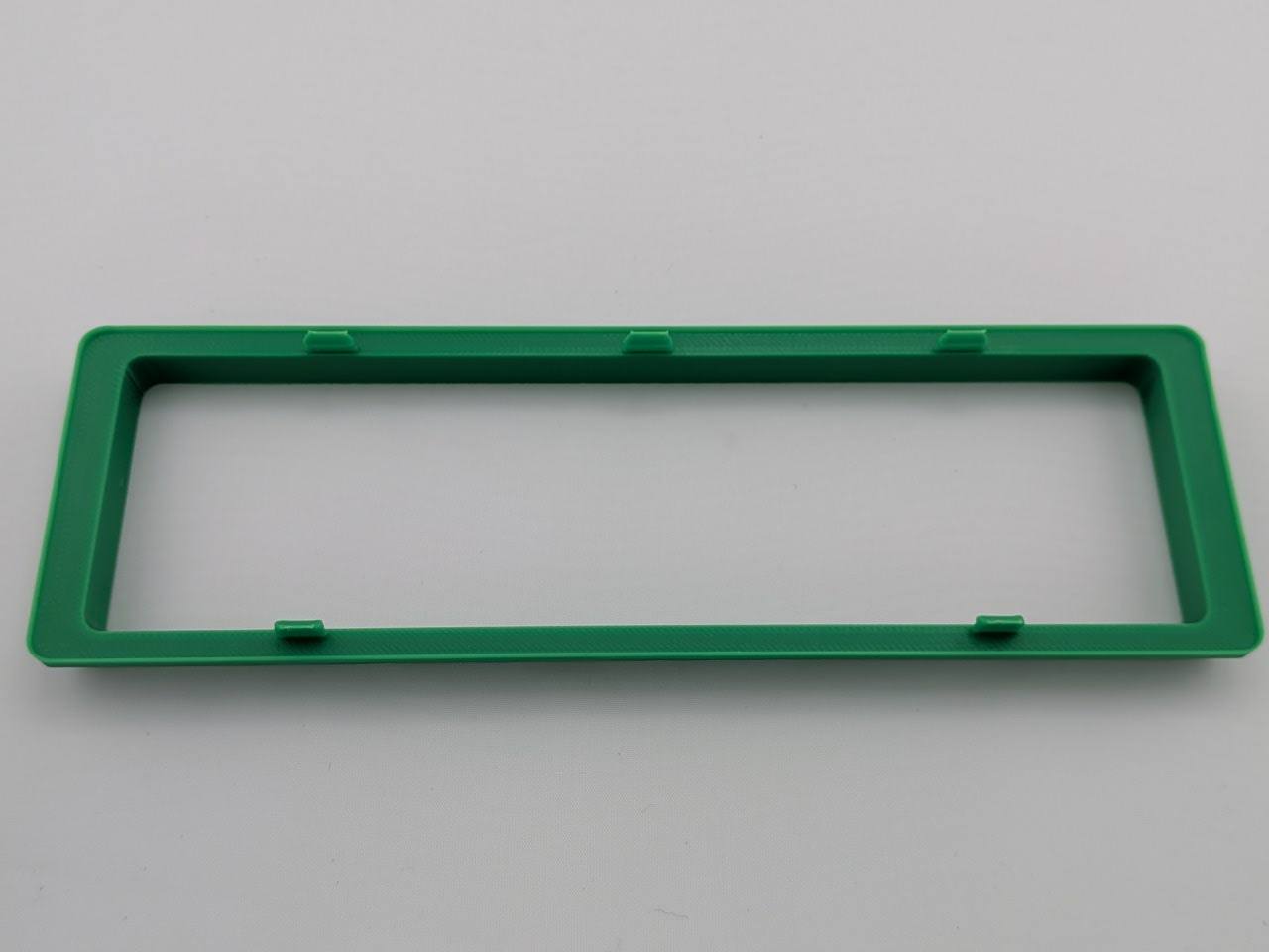 Green Alpine CD radio replacement bezel trim ring mounting tab close-up