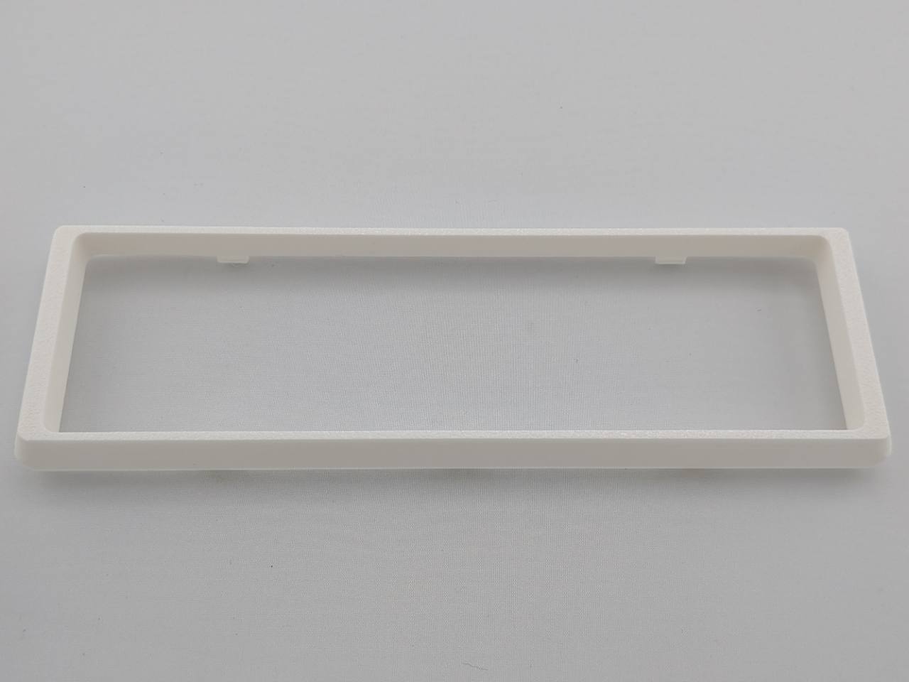White Alpine CD radio replacement bezel trim ring mounting tab close-up