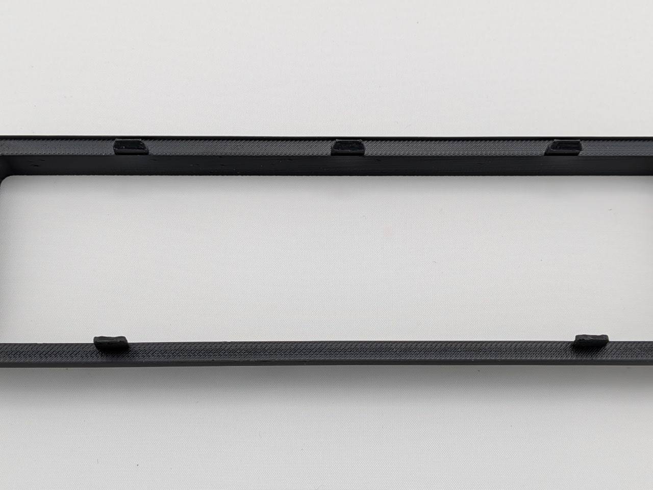 Black Alpine CD radio replacement bezel trim ring top surface detail