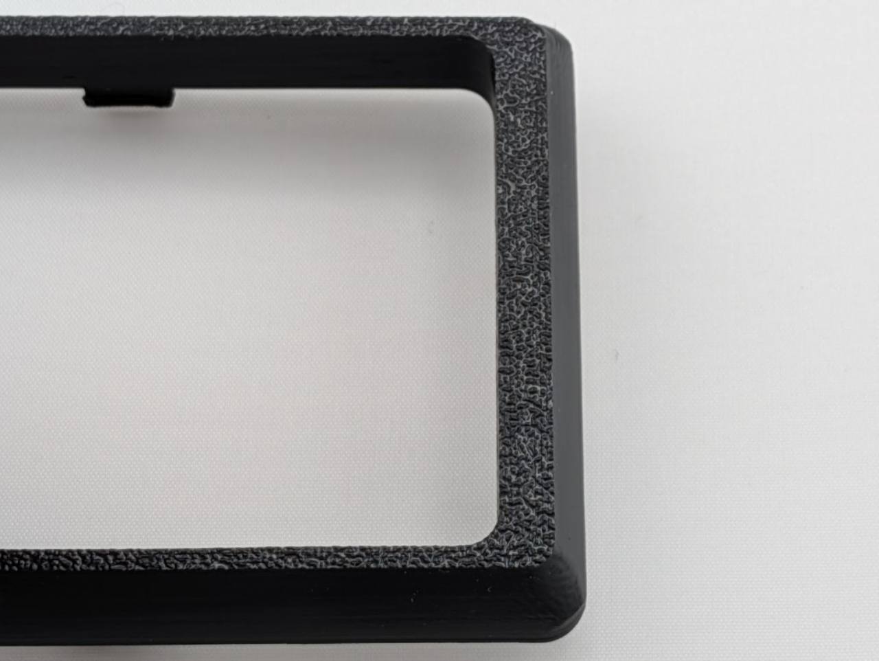 Black Alpine CD radio replacement bezel trim ring mounting tab detail