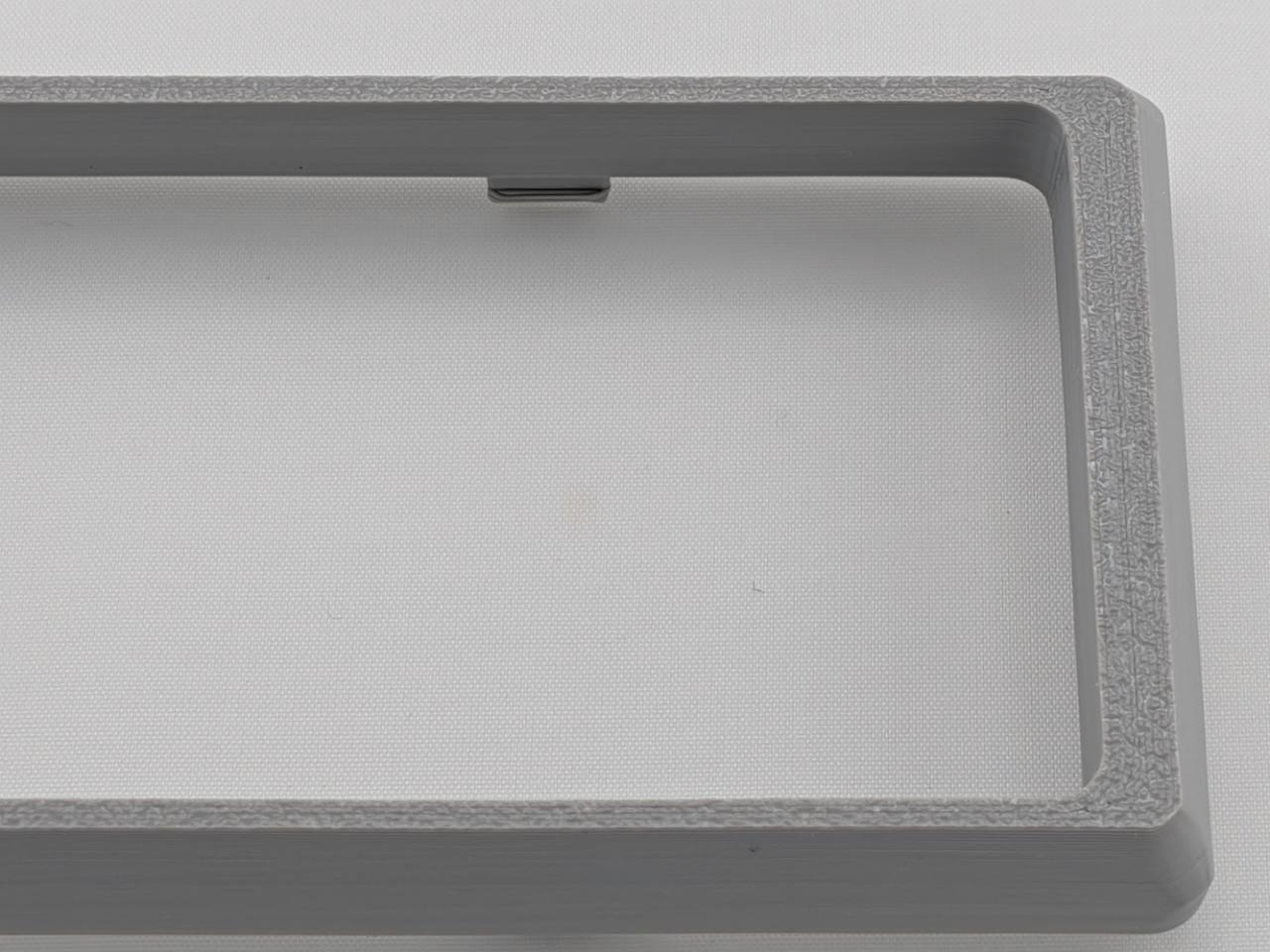 Gray Alpine CD radio replacement bezel trim ring corner and texture detail