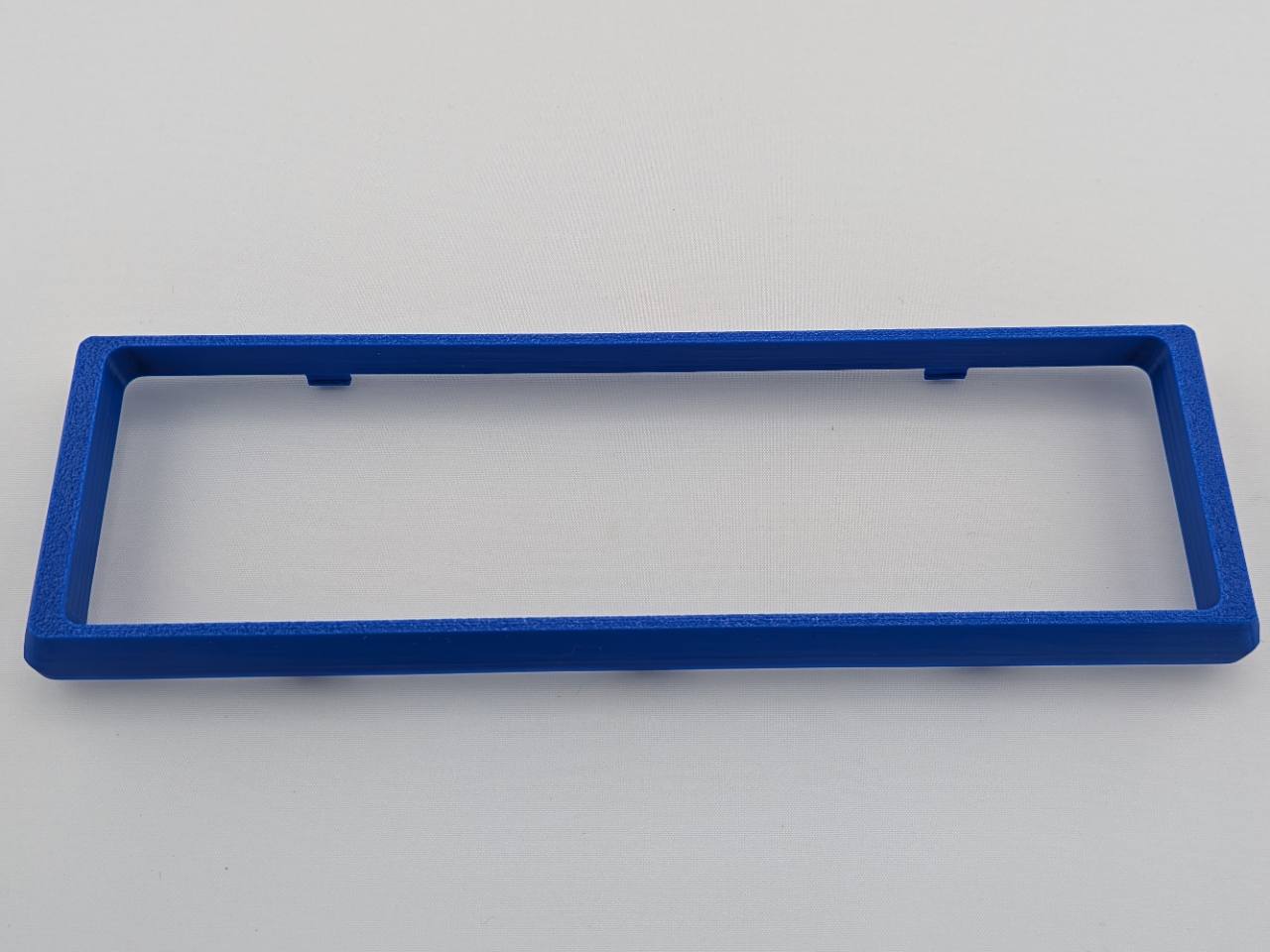 Blue Alpine CD radio replacement bezel trim ring mounting tab close-up