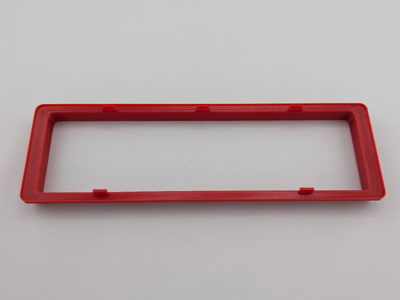 Red Alpine CD radio replacement bezel trim ring mounting tab close-up