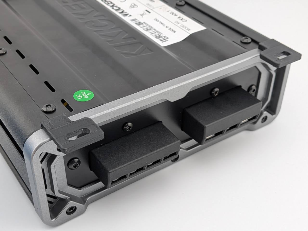 Close-up of two rear-corner Black horizontal mounting feet on a Kicker CXA400.1 amplifier; amplifier not included