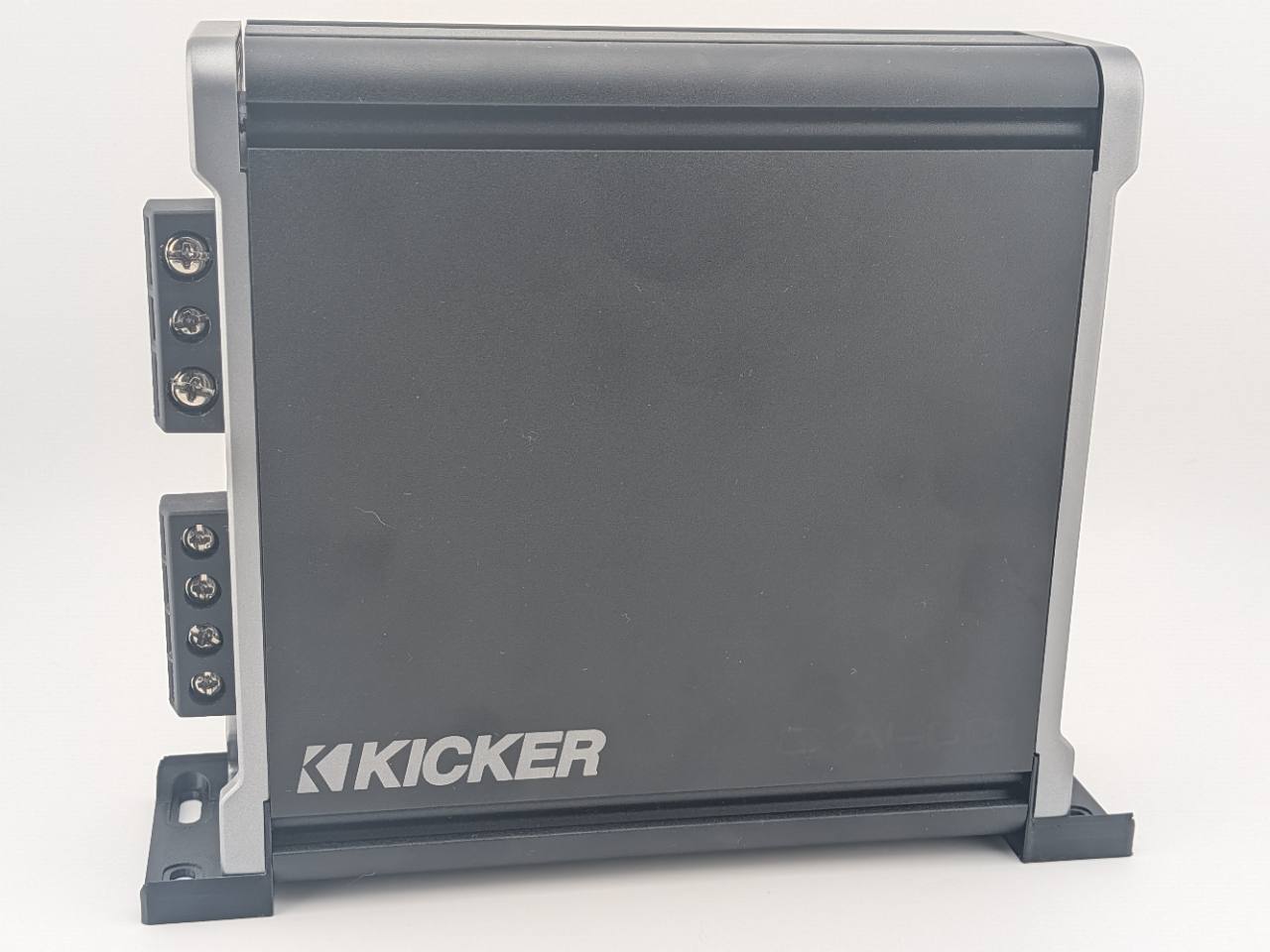 Black TightPrints vertical mounting feet installed on a Kicker 46CXA4001 amplifier; amplifier shown for fitment only and not included