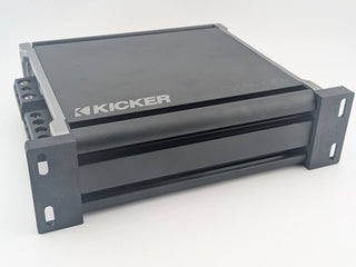 Angled fitment view of Black TightPrints vertical mounting feet on a Kicker 46CXA4001 amplifier; amplifier shown for fitment only and not included