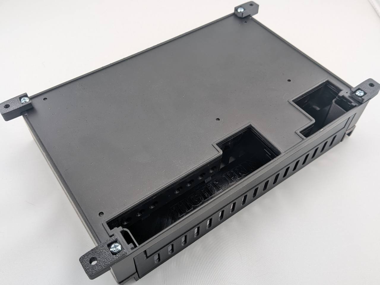 Four Black TightPrints replacement mounting feet installed on a compatible Kicker Stillwater Designs amplifier; amplifier and TightPrints detachable plate shown for fitment only and not included