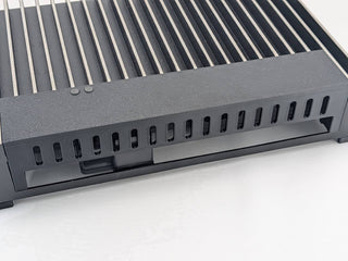 Black Kicker amplifier terminal cover installed on a compatible amplifier with lower wire access open; amplifier, mounting feet, screws, and hardware are not included, and the integrated breakaway panel ships attached