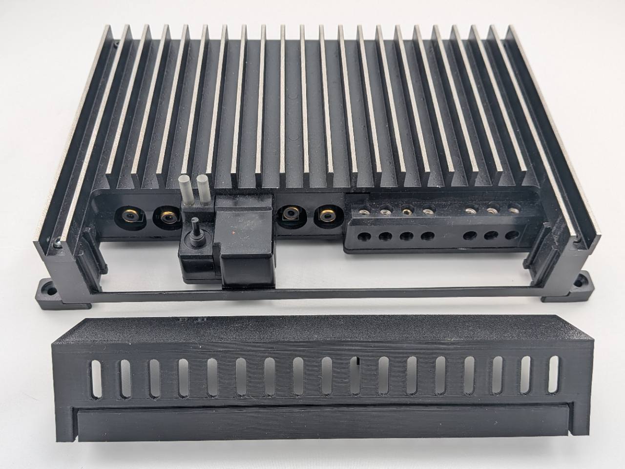 Compatible Kicker amplifier terminal area with the replacement cover removed; amplifier not included