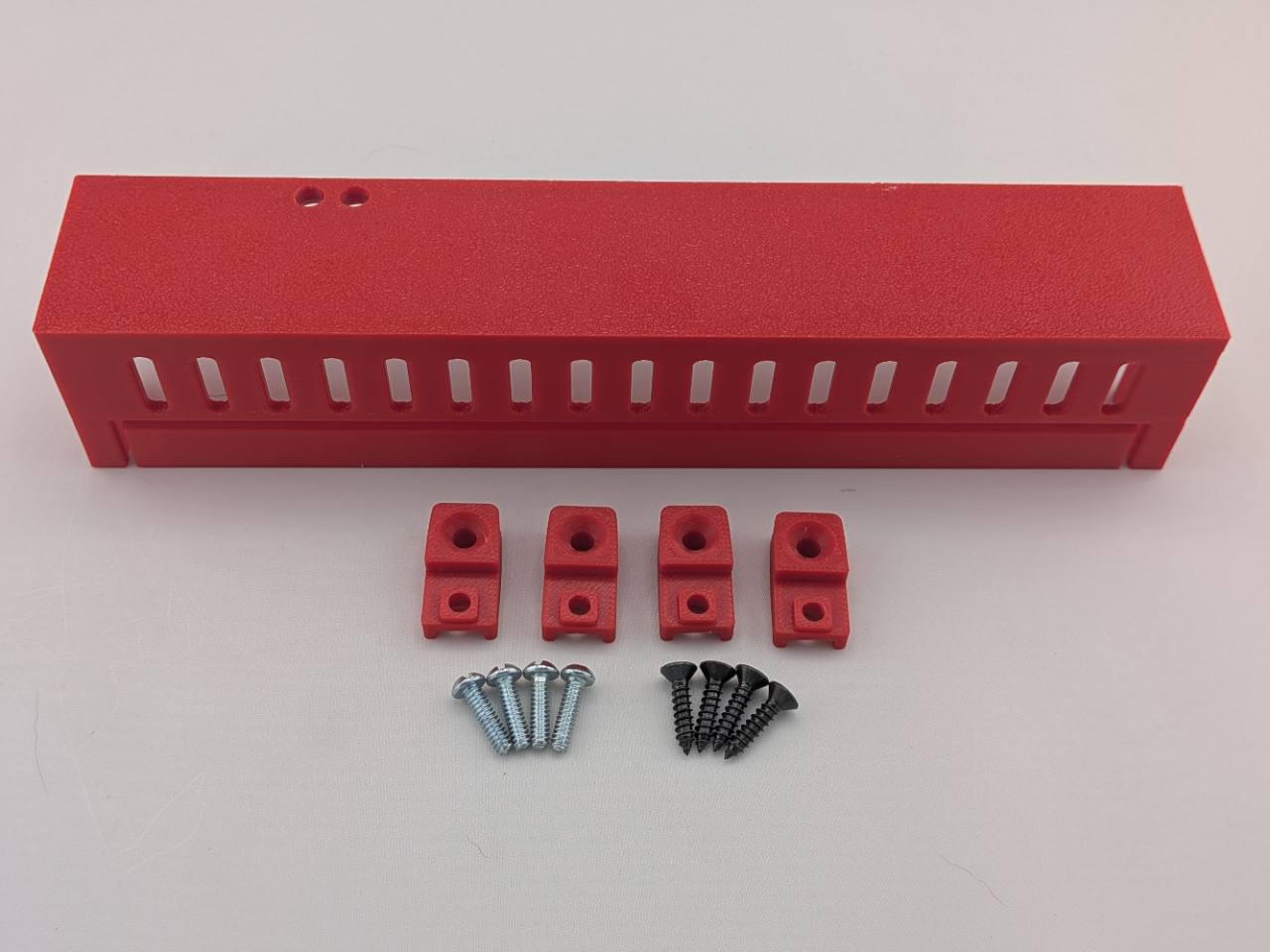 Red Kicker amplifier cover mounting feet kit with four silver screws and four black screws