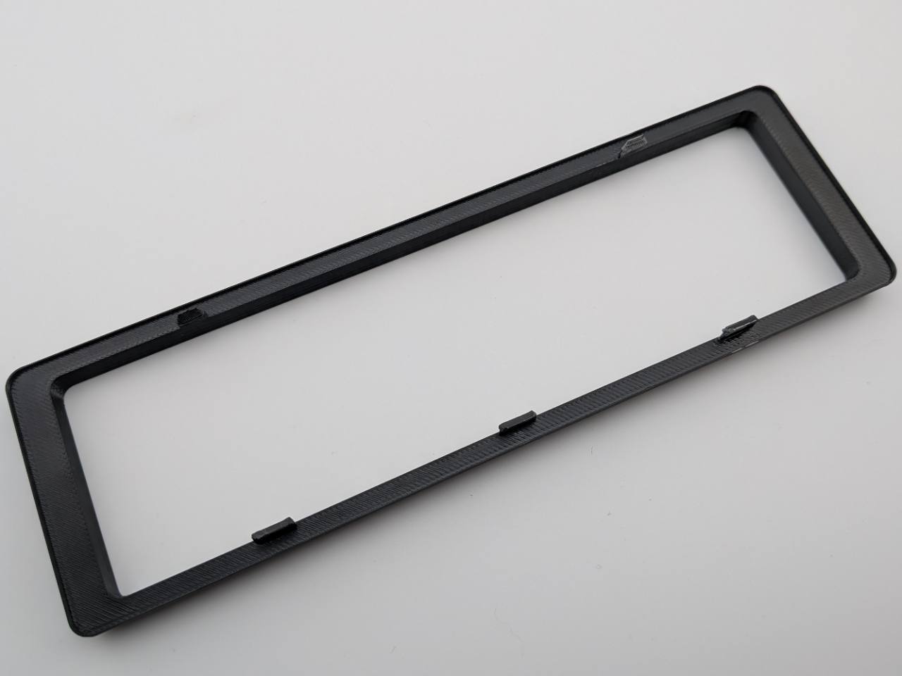 Black Alpine replacement trim ring rear construction and retention-tab detail