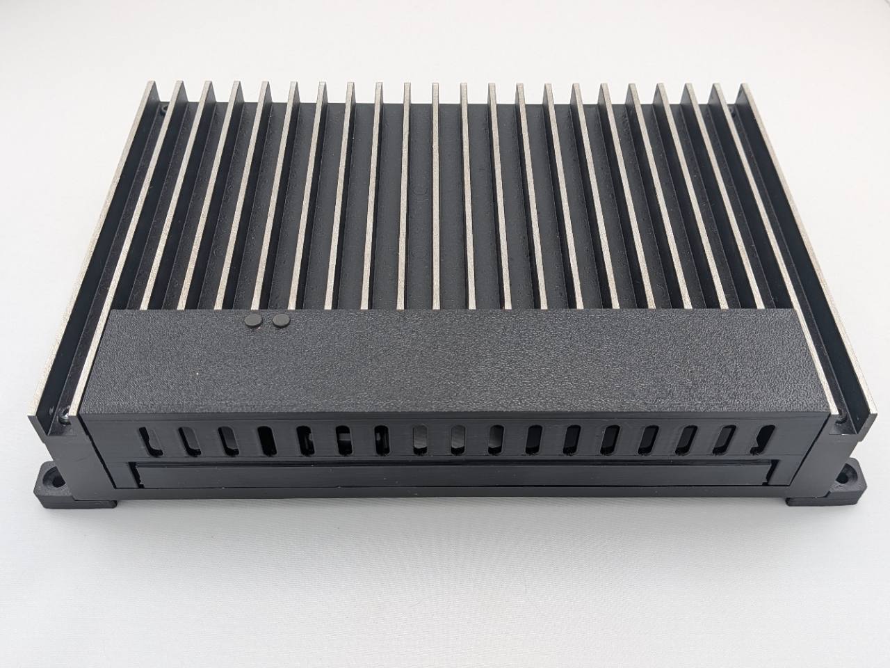 Black Kicker amplifier terminal cover installed intact on a compatible amplifier; amplifier, mounting feet, screws, and hardware shown for fitment only and not included