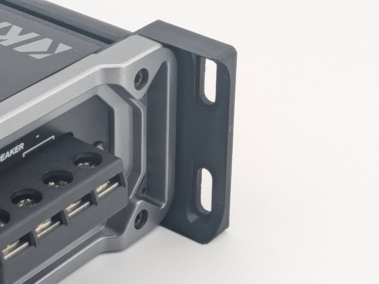 Close-up of a Black TightPrints vertical mounting foot attached to the end panel of a Kicker 46CXA4001 amplifier; amplifier not included