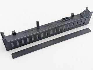 Black Kicker amplifier terminal cover interior with the integrated breakaway wire-access panel shown after optional removal; the panel ships attached as part of the one-piece cover
