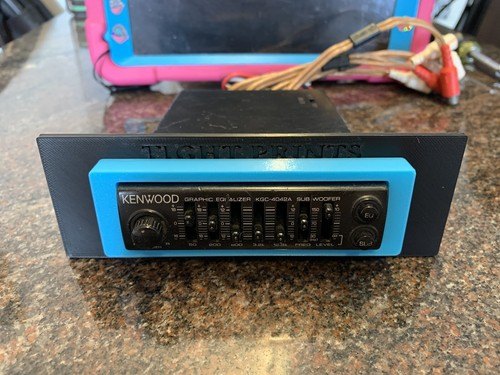Customer photo of a blue TightPrints trim part installed in a black Kenwood faceplate panel